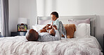 Love, father and son playing on bed for weekend bonding, connection and laughter for morning games. Pyjamas, relationship and caring man with child for tickling, happiness and family time in home