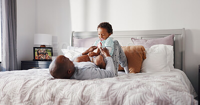 Buy stock photo Love, father and son playing on bed for weekend bonding, connection and laughter for morning games. Pyjamas, relationship and caring man with child for tickling, happiness and family time in home