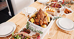 Food, thanksgiving or table setting with dinner for party, holiday meal or feast with vegetable dish and turkey. Above, house and cuisine with roast supper to celebrate, event and festive decor