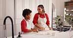 Christmas, mother and child with baking in kitchen for festive cookies, teaching recipe and help. African family, people or rolling pin in home for dough preparation, xmas snacks or holiday tradition