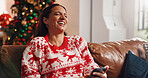 Christmas, home and woman on sofa with phone, online meme and festive smile in lounge. Xmas, person and vacation on couch with tech, holiday season and internet comedy or humor with website info