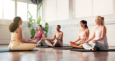 Buy stock photo Woman, yoga class and lotus meditation with coach, breathing exercise and routine on gym floor. People, zen and mudra with holistic fitness, teacher or mindfulness with guide on mat at wellness club