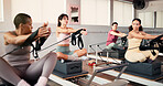 Reformer, stretching and women in class, instructor and fitness with pilates training. Healthy people, learning and group in wellness center, machine and exercise with equipment, feedback or strength