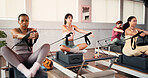 Women, reformer and pilates with resistance machine for stretching, flexibility or exercise in gym. Active, female person or group with fitness equipment in class for arm workout, balance or training