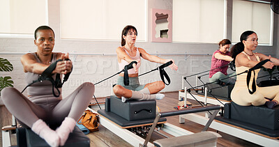 Buy stock photo Women, reformer and pilates with resistance machine for stretching, flexibility or exercise in gym. Active, female person or group with fitness equipment in class for arm workout, balance or training