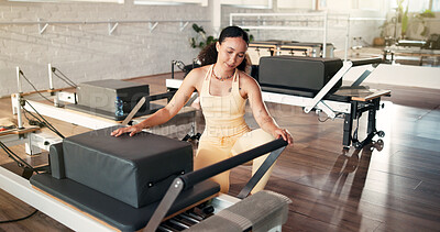 Buy stock photo Reformer machine, fitness and woman in studio, setup and wellness with preparation. Equipment, person and instructor in health center, spring change and pilates training with safety check and core