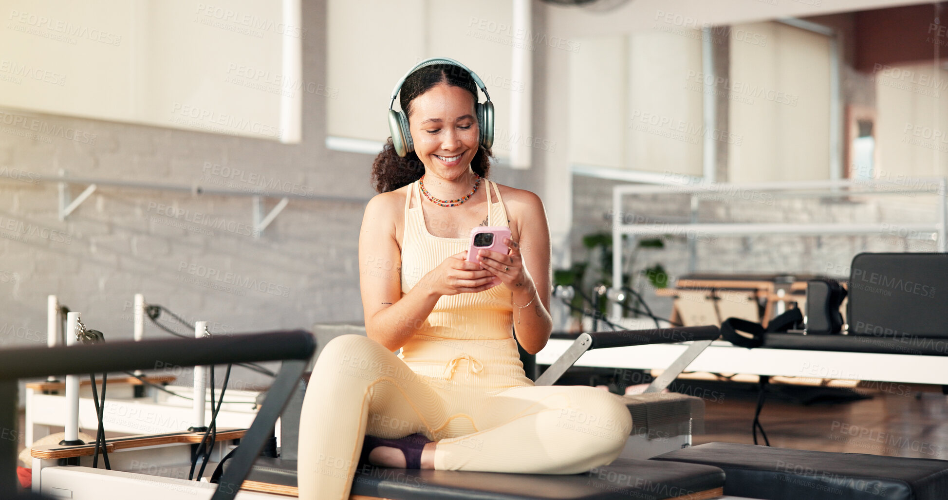 Buy stock photo Gym, headphones and woman with smartphone, happy and streaming music on break, app and entertainment. Health club, wellness and person with mobile for song selection, online or subscription for audio