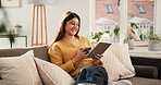 Woman, reading book and coffee on sofa, happy and relax with literature in living room at apartment. Person, smile and novel on couch in lounge for beverage, poetry and fiction story at house