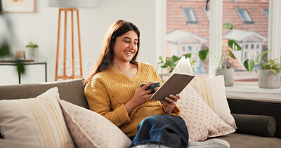 Buy stock photo Woman, reading book and coffee on sofa, happy and relax with literature in living room at apartment. Person, smile and novel on couch in lounge for beverage, poetry and fiction story at house