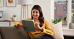 Streaming, smile or Indian woman on sofa with tablet, online reading or video update on social media. Happy, scroll or girl in house with tech, e book subscription or multimedia browse on digital app