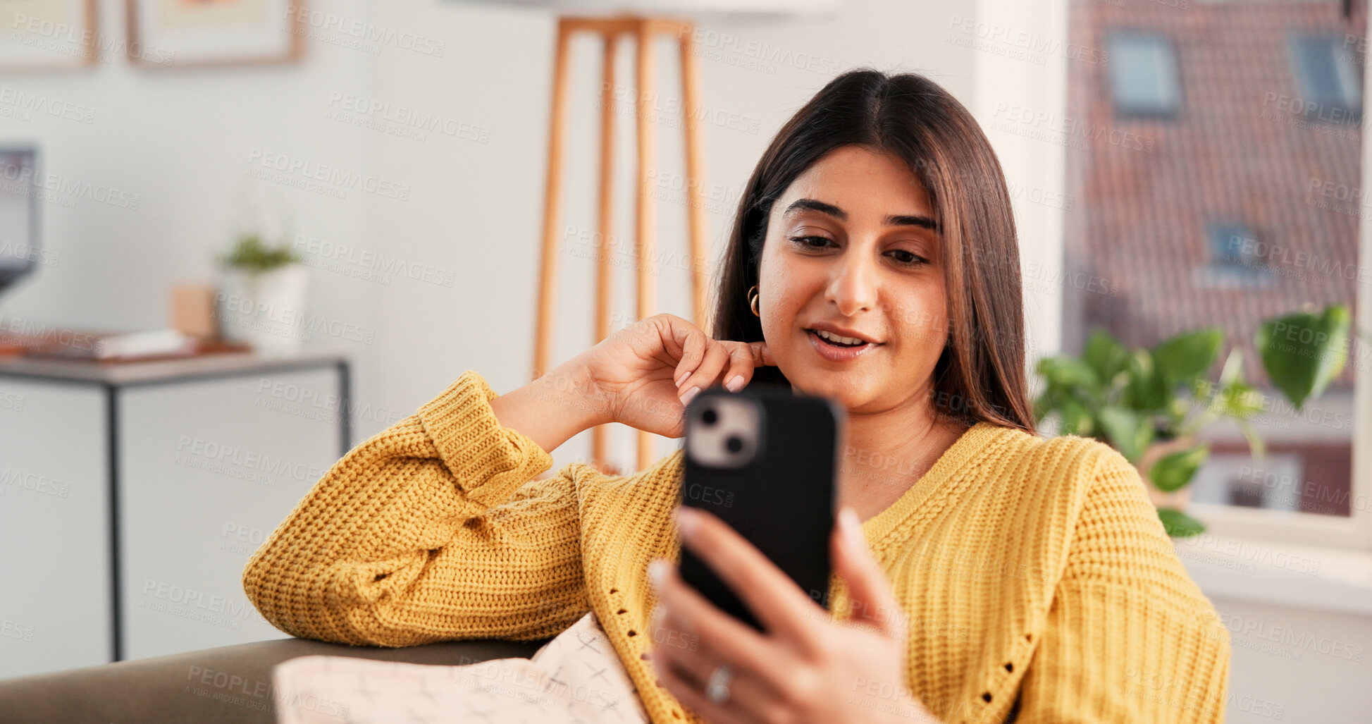 Buy stock photo Smartphone, smile and woman on video call in home for communication, talk and connection. Mobile, sofa and happy person with virtual chat in living room, relax and online conversation with contact