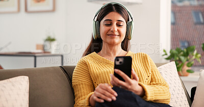 Buy stock photo Smartphone, headphones and woman with music in home, streaming podcast or listening to sound. Smile, mobile and person with audiobook in living room, online radio and relax with digital app on sofa