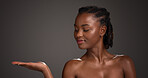 Mockup space, skincare and black woman in studio for product placement, beauty and wellness. Advertising, salon and person with hands for dermatology review, healthy skin and glow on dark background