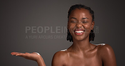 Buy stock photo Mockup space, skincare and happy black woman in studio for product placement, beauty and wellness. Advertising, salon and person with hands for dermatology, healthy skin and glow on dark background