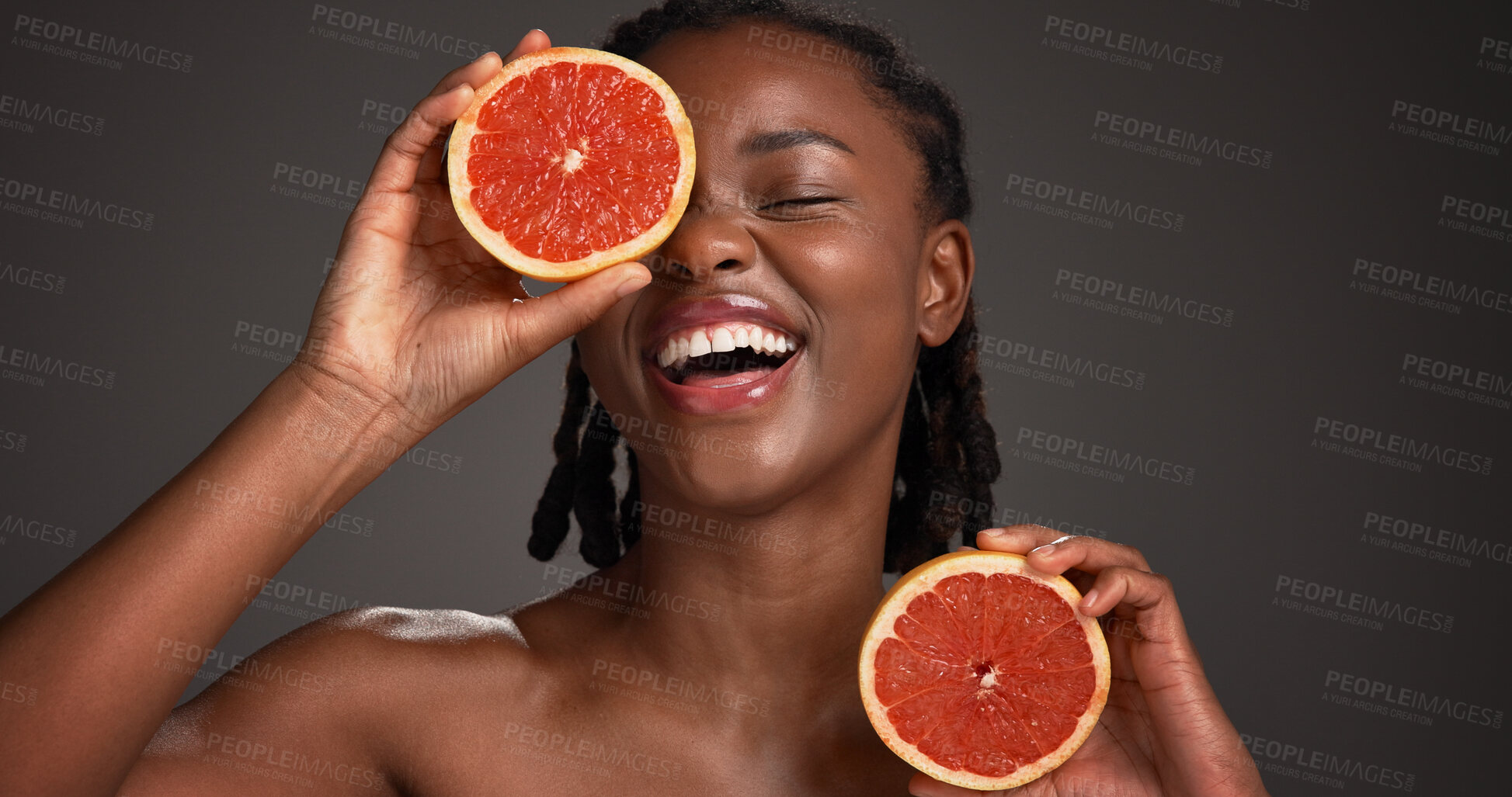 Buy stock photo Skincare, grapefruit and black woman in studio with hydration, health or organic facial glow. Vitamin c, space and African female person with citrus fruit for natural dermatology by gray background.
