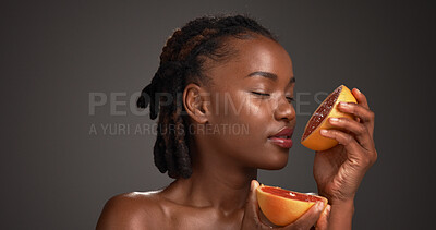 Buy stock photo Beauty, detox and grapefruit with black woman in studio for benefits of natural or organic diet. Citrus, fruit and vitamin c with African model isolated on gray background for health or wellness