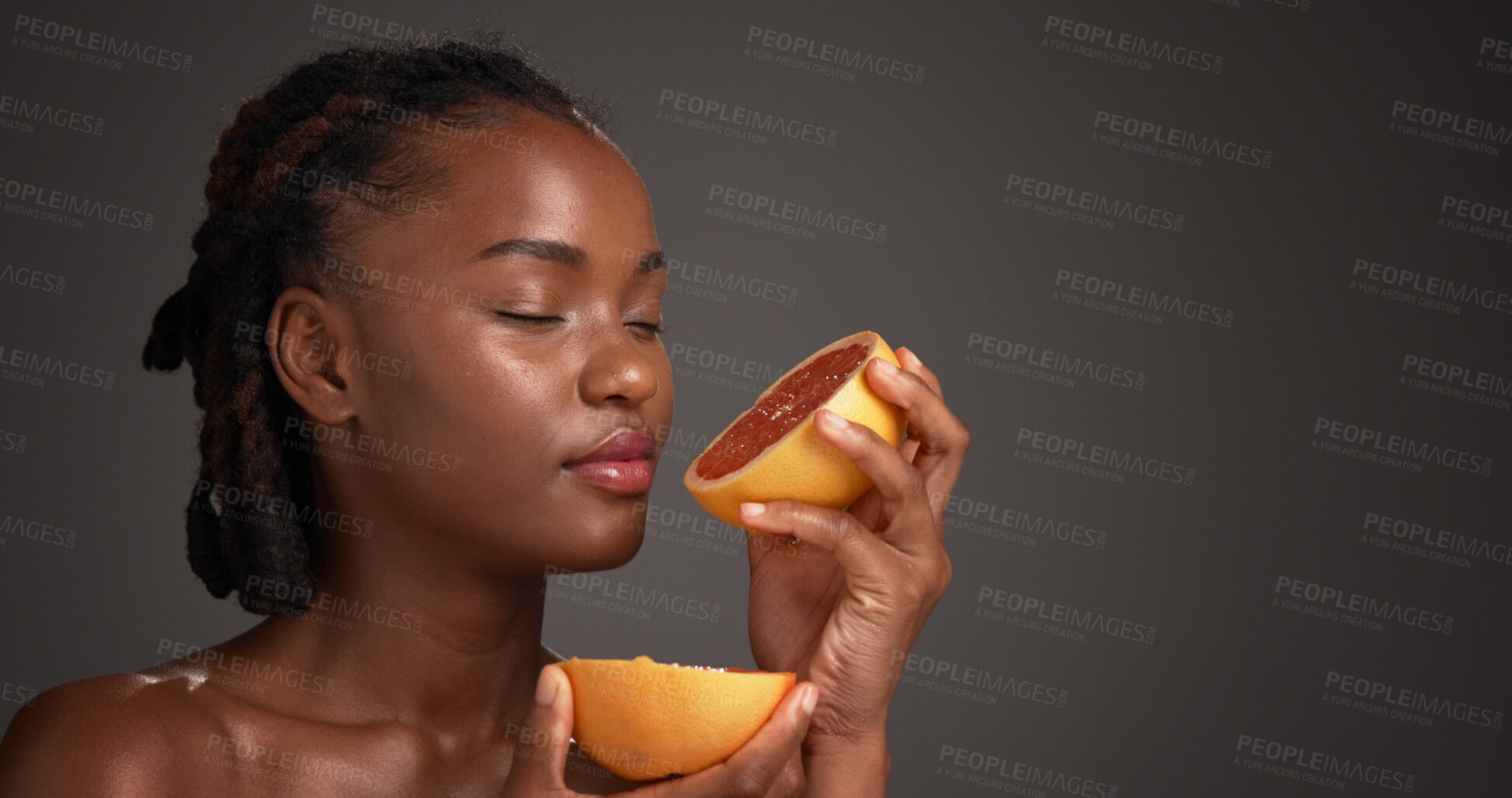 Buy stock photo Black woman, skincare and smell grapefruit in studio, mockup space and vitamin c on dark background. African person, citrus fruit and thinking with scent, organic product and benefits with beauty