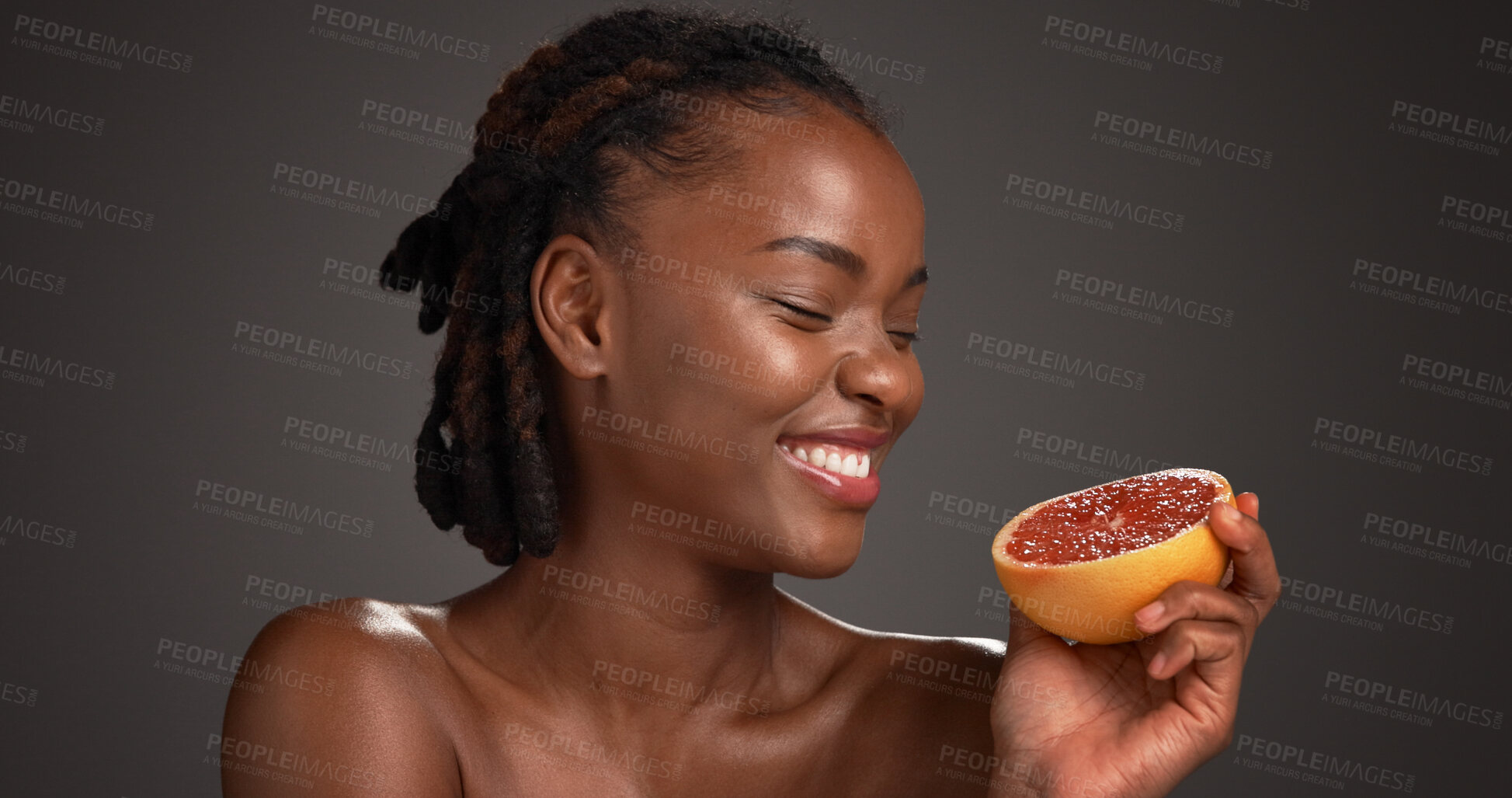 Buy stock photo Black woman, skincare and happy with grapefruit in studio, mockup space and vitamin c on dark background. African person, citrus fruit and thinking with smile, organic product or benefits with beauty