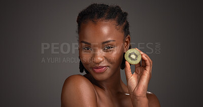 Buy stock photo Skincare, kiwi and portrait of black woman in studio for organic cosmetics, wellness and self care. Dark background, space and person with fruit for natural beauty, vitamins and dermatology benefits