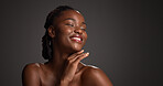 Skincare, space and happy black woman in studio for hydration, wellness and natural beauty. Mockup, dermatology and person with touch, smile and spa aesthetic for healthy skin on dark background