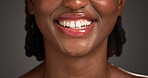Dental, closeup or black woman in studio with smile, mouth or tooth wellness in orthodontics. Lips, happiness and female person on gray background with hygiene, whitening or dentistry in oral health