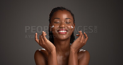 Buy stock photo Happy, black woman and studio with face cream for skincare or moisturizer on a gray background. Female person, model or smile with lotion, SPF or beauty cosmetics for anti aging skin on mockup space
