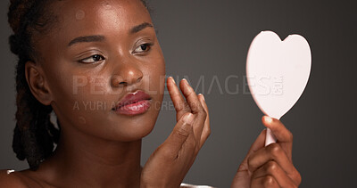 Buy stock photo Acne patch, mirror and skincare with black woman on studio space for cosmetics or dermatology. Beauty, inspection and routine with African model isolated on gray background to remove pimple or zit