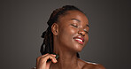 Happy, black woman and skincare with gua sha for facial massage on a gray studio background. Female person, model or relaxation with spa tool for collagen, lymphatic drainage or dermatology on space
