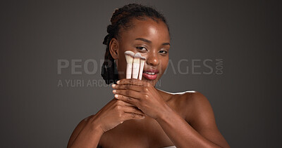 Buy stock photo Brush, makeup and portrait of black woman in studio for cosmetics, makeover and application. Cosmetology, space and person with tools for foundation, beauty products and aesthetic on dark background