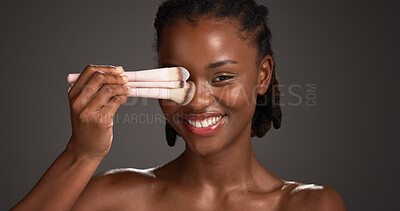 Buy stock photo Brushes, makeup and portrait of black woman in studio for cosmetics, makeover and application. Cosmetology, salon and person with tools for foundation, beauty products or aesthetic on dark background