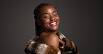 Beauty, makeup and pride with black woman in studio for aesthetic, cosmetics or fashion. Fur coat, glamor and space with smile of African model isolated on gray background for  luxury makeover