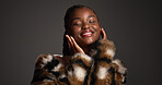 Luxury skincare, smile and black woman in studio with beauty, self care and glamour. Makeup, fur coat and model with cosmetics for aesthetic, healthy skin and touch face on dark background space