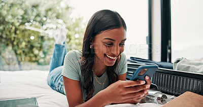 Buy stock photo Happy woman, travel and unpacking with phone in bed for vacation, holiday or accomodation in hotel. Female person, traveler or tourist with smile, mobile smartphone or suitcase for check in app