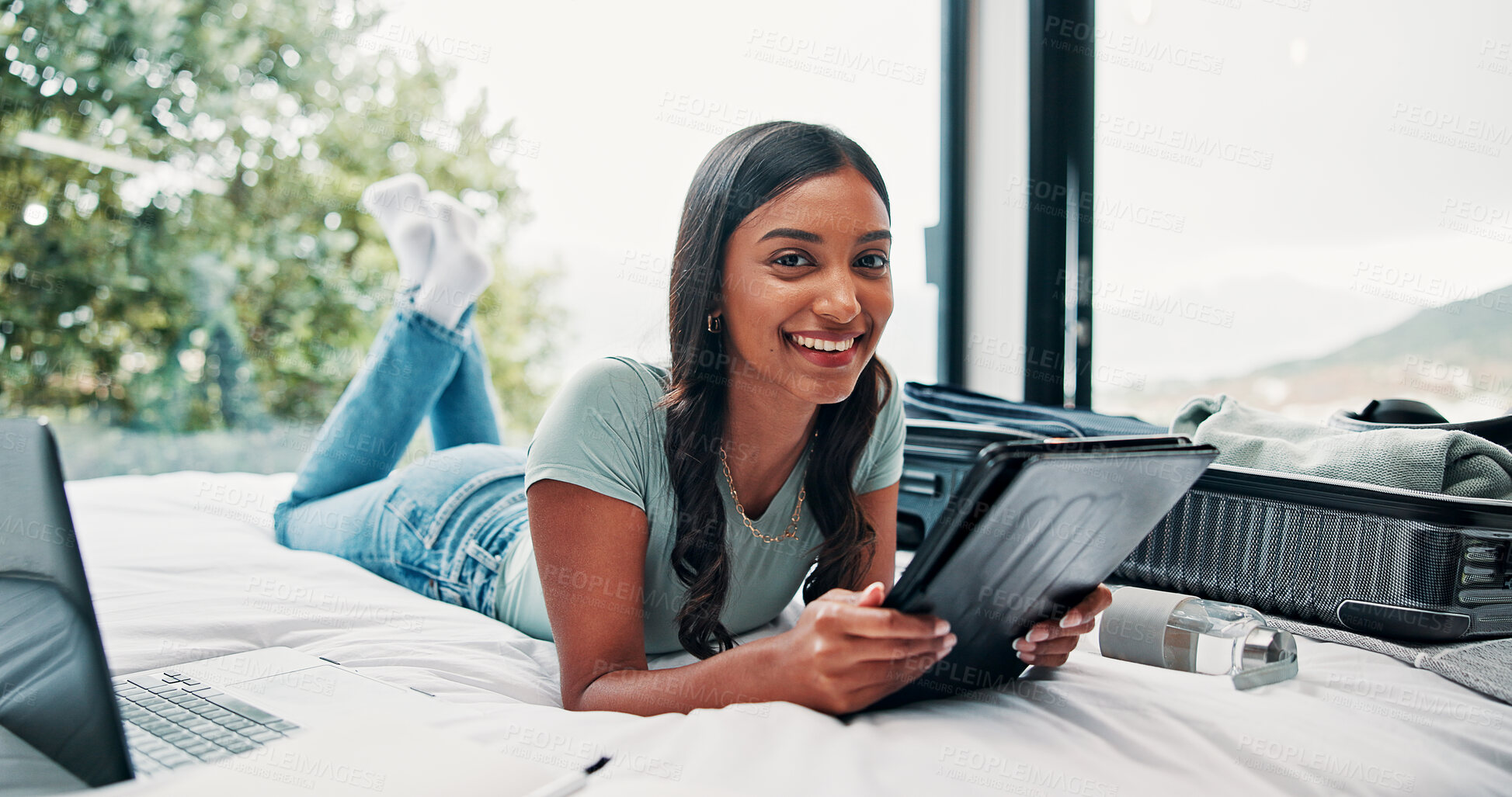 Buy stock photo Happy woman, portrait and travel with tablet on bed for holiday, weekend or vacation in hotel. Female person, traveler or tourist with technology, suitcase or laptop for online accommodation or app