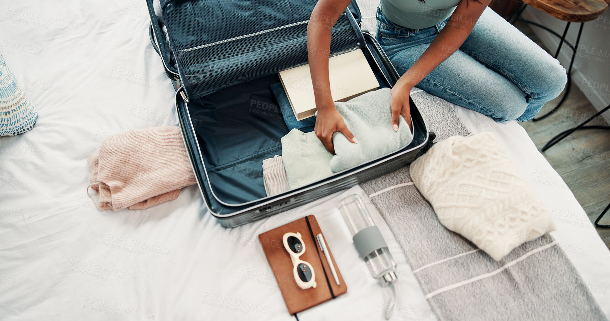 Buy stock photo Hands, packing and suitcase with person in bedroom of home for holiday, travel or vacation. Above, getting ready and luggage with tourist or traveler on bed in apartment for trip preparation