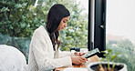 Reading, remote work and tablet with woman in home for online planning or research at window. App, development and scrolling with freelance employee at desk in apartment for small business startup