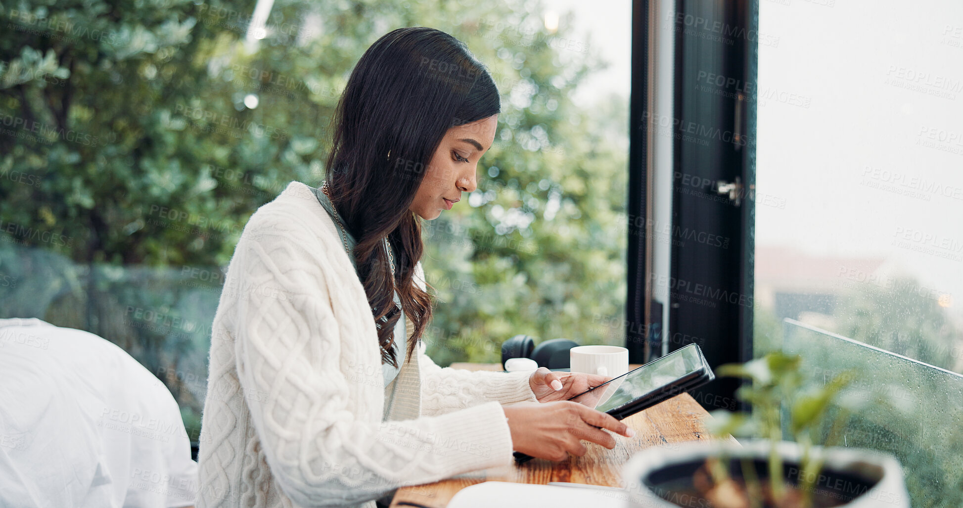 Buy stock photo Reading, remote work and tablet with woman in home for online planning or research at window. App, development and scrolling with freelance employee at desk in apartment for small business startup
