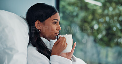 Buy stock photo Thinking, woman and coffee in bedroom for relax, peace and calm with morning beverage in home. Tea, reflection and Indian person in house with drink, daydreaming and remember memory on weekend break