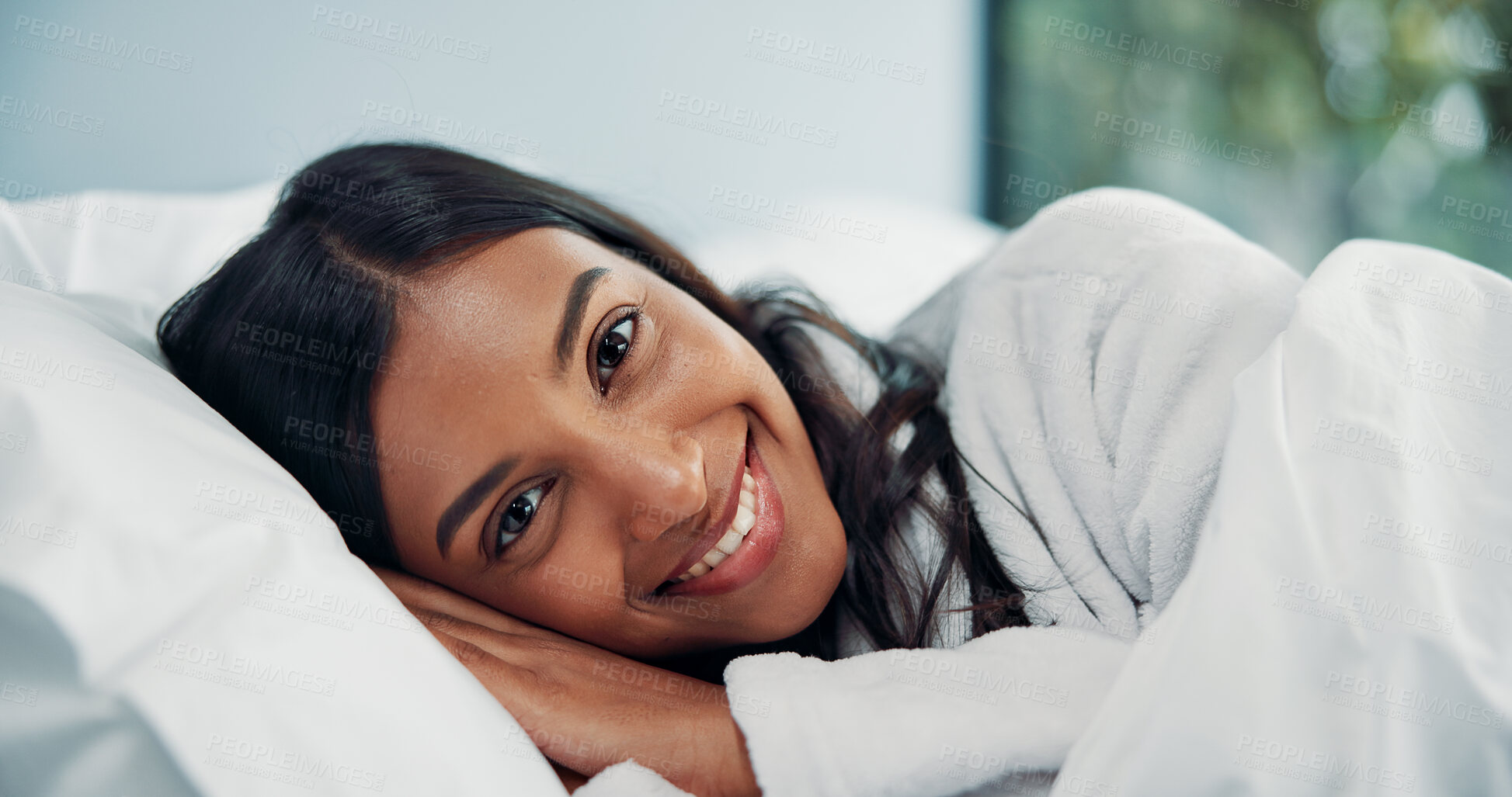 Buy stock photo Portrait, relax and smile of woman in bed for comfort, cozy or wellness on lazy weekend morning. Awake, break and travel with happy Indian person in hotel bedroom  for accommodation or hospitality