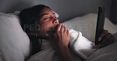Buy stock photo Yawn, night or woman in bed with phone, online reading or fatigue in social media browse. Dark, technology and female person in house with insomnia, tired or digital app scroll in late evening.