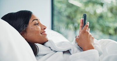 Buy stock photo Mobile, relax and happy woman in bedroom for internet communication, online dating app or chat. Rest, bed or Indian girl with phone for social media post, morning notification or profile info in home