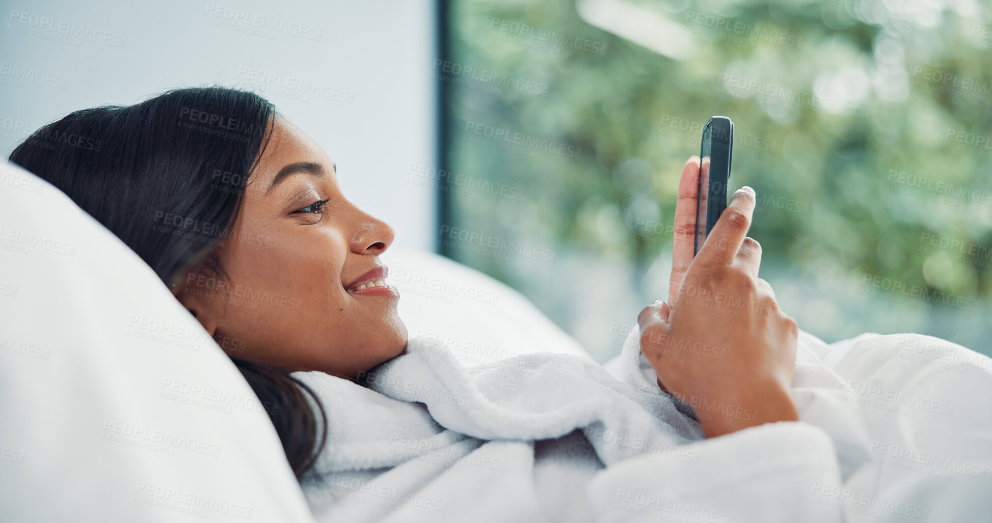 Buy stock photo Mobile, relax and happy woman in bedroom for internet communication, online dating app or chat. Rest, bed or Indian girl with phone for social media post, morning notification or profile info in home