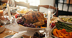 Table, setup and food for thanksgiving at house with roast turkey, health vegetables and celebration. Candles, feast or cuisine layout with wine glass, nutrition meal and lunch tradition for festive