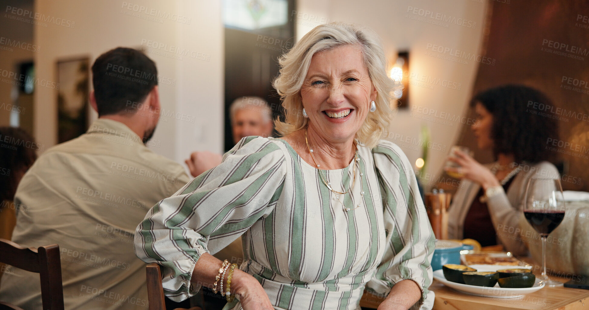 Buy stock photo Portrait, old woman and smile with family in dining room for dinner, social gathering and thanksgiving. Happy, senior person or bonding for reunion, celebration and tradition of festive event in home