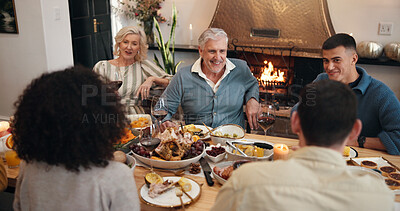 Buy stock photo Thanksgiving, smile and talking with family in dining room for holiday season, dinner or tradition. Festive feast, party and event with people eating in home for food, hosting and hospitality