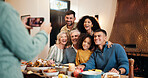 Christmas, food and photograph with family at dining room together for celebration or memories. Festive, picture and smile of happy people at table in home for feast, social gathering or tradition