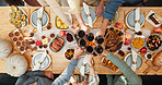 Thanksgiving, wine and cheers with hands of family for festive feast, celebration and dinner. Toast, alcohol drink and holiday season with above of people and glass in dining room of home for reunion