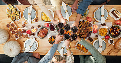 Buy stock photo Thanksgiving, wine and cheers with hands of family for festive feast, celebration and dinner. Toast, alcohol drink and holiday season with above of people and glass in dining room of home for reunion