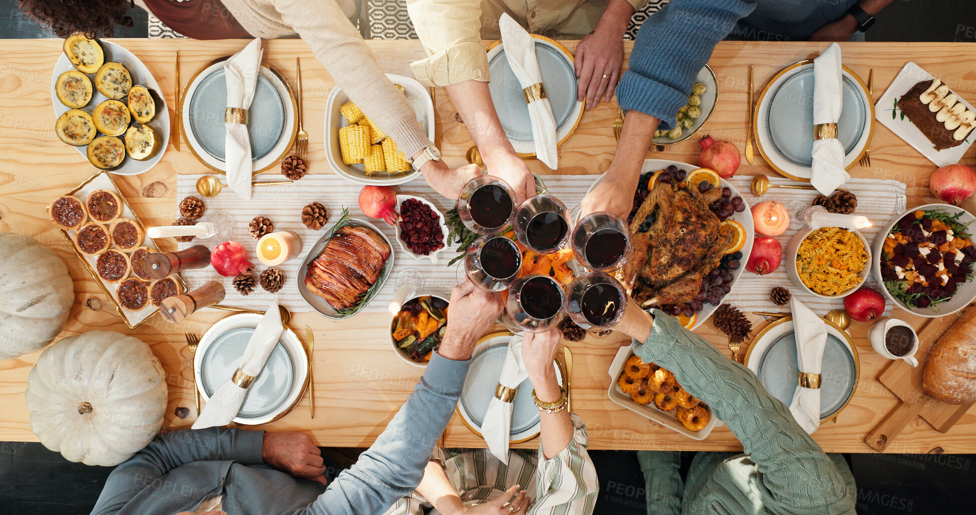 Buy stock photo Thanksgiving, wine and cheers with hands of family for festive feast, celebration and dinner. Toast, alcohol drink and holiday season with above of people and glass in dining room of home for reunion
