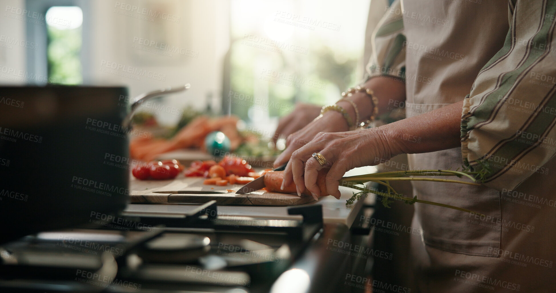 Buy stock photo Cooking, cutting and hands with old person in kitchen of home for healthy meal preparation. Busy, food and knife with senior woman chopping vegetables at counter in apartment for hunger or recipe